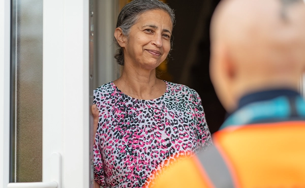 Employee talking to a customer a their front door