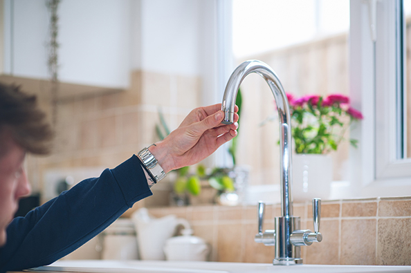 Customer inspecting looking at a kitchen tap