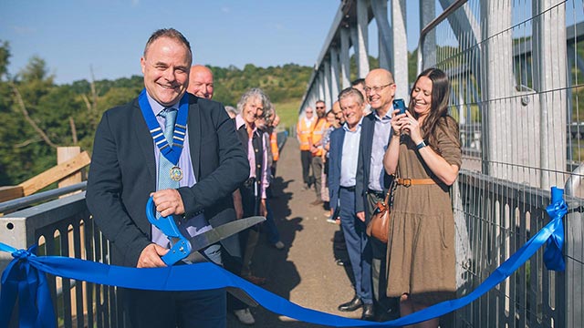 Saltford Parish Council chair, Cllr Jon Godfrey, cuts the ribbon on the Saltford side of the new footway