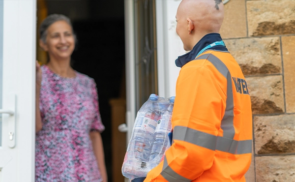 Employee delivering bottled water to customer