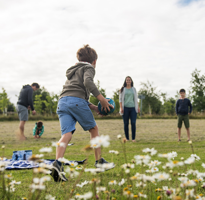 Family playing outside in a field