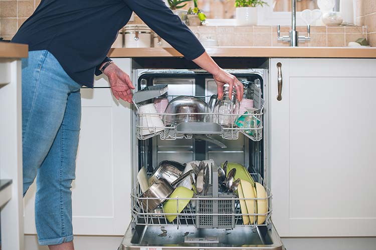 Customer loading a dishwasher